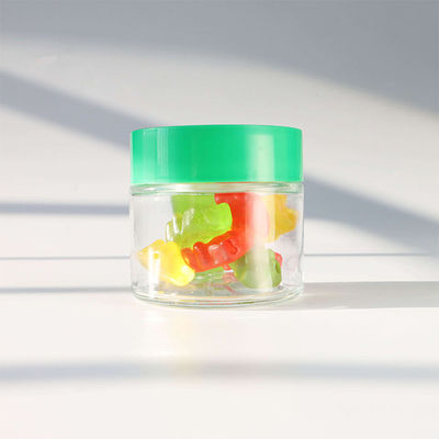 Contenant de stockage de bonbons en verre rond lisse avec un bouchon à vis résistant aux enfants