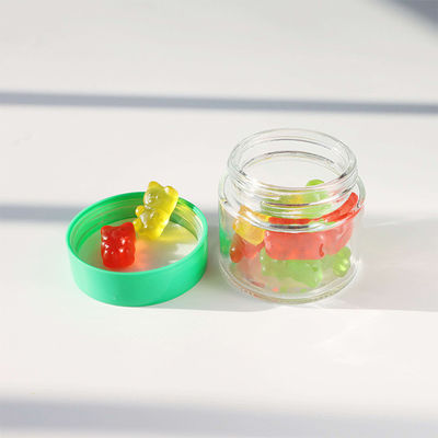 Contenant de stockage de bonbons en verre rond lisse avec un bouchon à vis résistant aux enfants